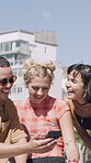 Phone, laughing and friends in city for outdoor hangout, chat and funny meme on social media. Happiness, sharing and group of people with communication, chat and reading on mobile in town for summer