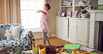 Dancing, music and child in home with ballet, energy or practice for performance with radio. Groove, rhythm and girl kid moving to playlist in living room with growth, fun and development in house.