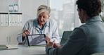 Doctor, patient and x ray with tablet screen, discussion and diagnosis for bone fracture in office. Healthcare worker, people and talk with tech, radiology scan and medical test results for injury.