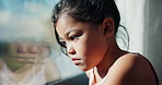 Sad, girl and thinking with window for trauma, mental health or anxiety on glass in home. Thoughtful, kid or child with depression, reflection or regret for outdoor fear, crisis or bullying in house