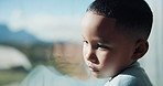Sad, boy and thinking with window for trauma, mental health or anxiety on glass in home. Thoughtful, kid or child with depression, reflection or regret for outdoor fear, crisis or bullying in house