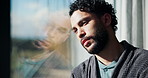 Sad, man and thinking with window for trauma, mental health or anxiety on glass in home. Thoughtful, doubt or male person with depression, reflection or regret for outdoor fear or crisis in house