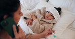 Mom, sick child or phone call with thermometer in bed for telehealth, assistance or help in home. Mother, kid or talking with smartphone, worry or fever for health advice, flu symptoms or temperature