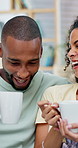 Happy couple, coffee and talk with laugh on sofa for bonding, connection and funny story in home. African people, smile and conversation with drinks, beverage and relax with relationship at house