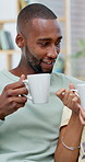 Happy couple, coffee and relax with laugh on sofa for bonding, connection and funny story in home. African people, smile and conversation with drinks, beverage and love with relationship at house