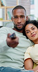 Movie, remote and African couple watching tv on sofa in home with subscription service for bonding. Love, connection and man with woman for streaming film, show or series for entertainment or date