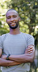 Outdoor, face and black man with arms crossed for fitness, cardio training and routine for wellness. Portrait, bokeh and runner in park for endurance practice, smile and confidence for health goals