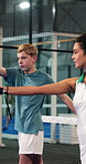 Padel, swing and child with trainer on court for learning to serve, skills and practice for game. Fitness, tennis and coach with boy for lesson, exercise and training with racket for tournament