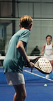 Padel, playing and boy with coach on court to practice skills for game, match and competition. Tennis, sports and teenager with racket for training, fitness and exercise with trainer for lesson