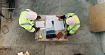 Construction, blueprint and above of people for planning, building project and inspection outdoor. Civil engineer, meeting and men with paperwork and tech for floorplan, design or infrastructure team