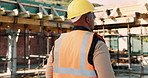Thinking, construction and back of man in city for urban planning, building project and repair. Civil engineer, helmet and African person with reflection, ideas and ppe for safety in infrastructure