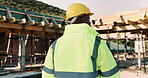 Planning, construction and back of man with helmet for site inspection, building and remodeling. Civil engineer, thinking and African person with ppe for infrastructure, project and safety outdoor