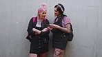 Wall, students and happy women with phone, fashion and reading message on social media app or online. University, friends and people with streetwear, punk and laughing with mobile and mockup space