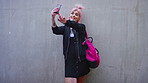 Social media, smile and woman on wall with selfie, feed update or photo capture for online post. Happy, space and female person with picture, content creation or digital memory in Los Angeles.