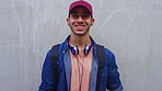 Face, man and student with smile at wall for education, scholarship and studying abroad. Outdoor, portrait and male person with mockup space, learning opportunity and happiness for college knowledge