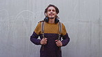 Backpack, headphones and face of student man outdoor for education, learning or university study. College, school and smile of pupil on concrete background at campus for knowledge or opportunity