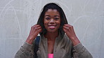 Face, hoodie and learning with black woman on concrete background for commute or travel to school. Cover, education and smile with student outdoor for trip to college to university in winter