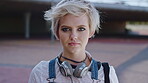 Education, face and serious with woman on campus for college, school or university study. Future, headphones and learning with confident student outdoor for knowledge, opportunity or scholarship