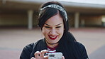 Laughing, college student and woman outdoor with phone, reading school newsletter and funny message. Internet humor, happy and person with mobile on campus, web chat notification and joke in forum