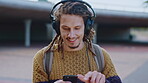 Education, music and phone with man on campus for college, school or university study. Dreadlocks, headphones and smile of Rastafarian student outdoor for learning, scholarship app or streaming