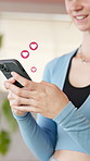 Heart, hands and woman with mobile emoji for love, online dating and overlay at fitness gym. Happy person, phone and typing with social media symbol, icon and romantic update with notification on app