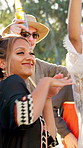 Friends, dancing and happy at festival in summer with drinks, outdoor and excited at party in nature. People, group and spring break with alcohol, concert or rhythm with celebration on getaway