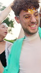Smile, man and dancing with people at music festival for fun, celebration and energy at live concert. Happy, person and audience at groove event, freedom and moving with rhythm at outdoor rave party