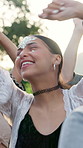 Happy, woman and dancing with people at music festival for fun, celebration or energy at live concert. Smile, female person and groove with crowd, freedom and moving with rhythm at outdoor rave party