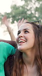 Excited, woman and friends dancing at festival for fun, celebration and energy at live concert. Smile, people or embrace for social gathering, dance floor and moving with rhythm at outdoor rave party