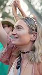 Smile, woman and dancing with people at music festival for fun, celebration or energy at live concert. Happy, female person and groove with crowd, freedom and moving with rhythm at outdoor rave party