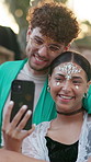 Couple, selfie and happy at festival, outdoor and glitter with hug, bonding and summer holiday. People, partner and photography with smile, memory or mobile app for social network on spring break