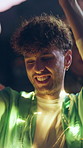 Man, night and dancing at music festival with smile for fun, celebration and energy at live concert. Happy, person and lights at groove event, freedom and moving with rhythm at outdoor rave party