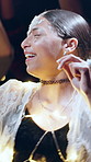 Festival, dance and woman with lights at night, fun or listening to music entertainment with friends. Dark, event and people with smile for celebration, bokeh and social gathering for festive season