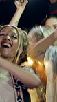 Night, festival or dancing with happy people in outdoor party for fun music concert or celebration. Excited, group or community jumping with phone lights in late evening for sound or festive event