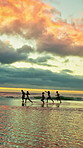 Running, friends and fun at beach for holiday, bonding or together in nature on weekend and freedom. Outdoor, sunset and reunion on summer vacation, space and travel with people on ocean adventure