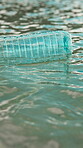 Plastic, pollution and trash with bottle in ocean for environment problem, waste management and litter. Recycling fail, water hazard and illegal dumping of garbage in sea for climate crisis outdoor