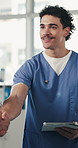 Doctor, man and tablet at handshake at clinic with smile for success, goals or motivation with team. People, tech and support for celebration, shaking hands and app for healthcare service in hospital