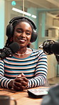 Woman, podcast and interview with mic, headphones and conversation for broadcast in recording studio. Happy, creative people and guest speaking with radio presenter, collaboration or online talk show