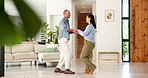 Couple, dance and holding hands with smile in home for bonding, connection and laugh in lounge. Happy man, woman and partner with rhythm, care and fun in relationship with movement at apartment