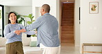 Couple, dance and holding hands with smile in house for bonding, connection and laugh in lounge. Happy man, woman and partner with rhythm, care and fun in relationship with movement at apartment