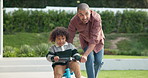 Learning, bicycle and dad with child outdoor for teaching balance, cycling skills and bonding together. Family, neighborhood and father with boy on bike for hobby, relationship and fun on weekend