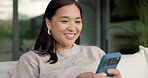 Happy, chatting or asian woman with phone for social media, online texting or app on sofa in home. Female person, user or smile with smartphone for mobile conversation, discussion or message in house