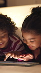 Relax, tablet and children in bedroom at house at night with choice on movie, show or series online. Happy, digital technology and kids with streaming film on app, website or internet in apartment.