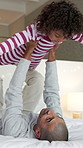 Happy, dad or bed with child in air for playful bonding, weekend or fun childhood in home. Father, kid or boy flying with smile, love or care in bedroom for holiday, fantasy plane or support in house