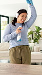Dance, happy and woman with headphones for cleaning, housework and maintenance in home. Singing, radio and person with spray bottle, movement and music for housekeeping, disinfection and bacteria