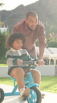 Teaching, bicycle and father with child in nature for bonding, activity or love together on weekend. Happy, learning and dad with kid with cycling on bike outdoor in park for connection with family.