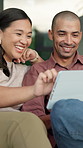 Couple, laughing and bonding with tablet in lounge, scroll and watching funny video on social media. Happy people, home and streaming comedy movie with partner, online and relax with tech on weekend