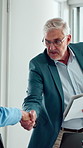 Welcome, handshake and business man in office meeting, contract agreement or financial partnership. Greeting, mature person and shaking hands with team, investment paperwork or b2b acquisition