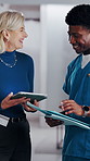 Doctor, nurse and discussion with tablet in clinic, patient status update and treatment schedule file. Teamwork, physician and happy people with tech for care coordination, laugh and medical report