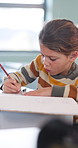 Art, education and activity with girl in classroom for test, child development or knowledge. Studying, assessment and academy with student on school campus for learning, course curriculum and drawing